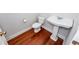 Small bathroom with pedestal sink, toilet, and hardwood floors at 2517 Charter Oaks Dr, Mount Pleasant, SC 29466