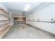 A spacious garage area with overhead lighting, shelving, and a workbench area for projects and storage at 2517 Charter Oaks Dr, Mount Pleasant, SC 29466