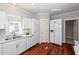 Bright kitchen boasts white cabinets, stainless steel appliances, and hardwood floors at 2517 Charter Oaks Dr, Mount Pleasant, SC 29466