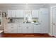 Well-equipped white kitchen with quartz countertops and hardwood floors at 2517 Charter Oaks Dr, Mount Pleasant, SC 29466