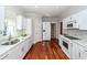 Bright kitchen with white cabinets, granite counters, and hardwood floors at 2517 Charter Oaks Dr, Mount Pleasant, SC 29466
