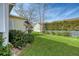 Spacious backyard with grassy lawn, bird feeder, and privacy fence at 2725 Battery Pringle Dr, Johns Island, SC 29455
