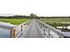 Long community boardwalk over the marsh with a small gazebo on the side at 2725 Battery Pringle Dr, Johns Island, SC 29455