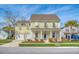 Two-story yellow house with white columns, shutters, and a two-car garage at 2725 Battery Pringle Dr, Johns Island, SC 29455