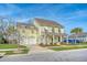 Beautiful two-story yellow house with white columns, shutters, and a two-car garage at 2725 Battery Pringle Dr, Johns Island, SC 29455