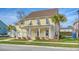 Attractive two-story yellow house with white columns, shutters, and a two-car garage at 2725 Battery Pringle Dr, Johns Island, SC 29455
