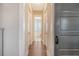 Long hallway with hardwood floors and doors to bedrooms and bath at 2725 Battery Pringle Dr, Johns Island, SC 29455