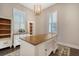 Bright home office features a wood desk, built-in shelving, and window shutters at 2725 Battery Pringle Dr, Johns Island, SC 29455