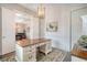 Home office with shiplap wall, wood desk, and access to dining room at 2725 Battery Pringle Dr, Johns Island, SC 29455