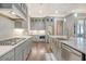 Modern kitchen with gray cabinets, stainless steel appliances, and a large island at 2725 Battery Pringle Dr, Johns Island, SC 29455