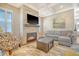Spacious living room features a fireplace, sectional sofa, and hardwood floors at 2725 Battery Pringle Dr, Johns Island, SC 29455