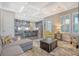 Bright living room with gray sectional sofa, yellow armchair, and kitchen views at 2725 Battery Pringle Dr, Johns Island, SC 29455