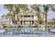 Community pool surrounded by mature palm trees and lounging chairs at 2725 Battery Pringle Dr, Johns Island, SC 29455