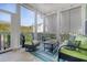 Relaxing screened porch with comfy seating and string lights at 2725 Battery Pringle Dr, Johns Island, SC 29455
