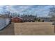 A large, grassy backyard with a storage shed, home, and other buildings at 2830 Wire Rd, Saint George, SC 29477