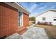 Red brick building in the backyard with a concrete slab and a view of the white-sided house at 2830 Wire Rd, Saint George, SC 29477