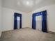 Bedroom with neutral carpet and two windows dressed with beautiful blue curtains at 2830 Wire Rd, Saint George, SC 29477