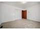 Bedroom with neutral carpet, a closet, a door leading to another room and fresh, white paint at 2830 Wire Rd, Saint George, SC 29477