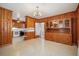 Cozy dining room with wooden walls, built-in hutch, and adjacent kitchen for convenient dining at 2830 Wire Rd, Saint George, SC 29477