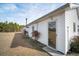 Charming exterior featuring white siding, manicured landscaping, and a glass door entrance at 2830 Wire Rd, Saint George, SC 29477