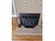 Fireplace with brick surround and black metal insert at 2830 Wire Rd, Saint George, SC 29477