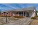 Charming brick home featuring a covered porch and well-maintained landscaping at 2830 Wire Rd, Saint George, SC 29477