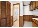 Hallway has wood paneling and trim with a view into a half bathroom and closet at 2830 Wire Rd, Saint George, SC 29477