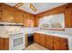 Functional kitchen featuring wooden cabinetry, white countertops, and modern appliances at 2830 Wire Rd, Saint George, SC 29477