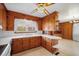 Spacious kitchen featuring wooden cabinetry, white countertops, and a breakfast bar with ceiling fan at 2830 Wire Rd, Saint George, SC 29477