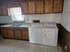 View of the laundry room, with vintage cabinets, sink, and a washer/dryer at 2830 Wire Rd, Saint George, SC 29477