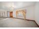 Bright living room with chandelier, large window and a paneled glass entry door at 2830 Wire Rd, Saint George, SC 29477