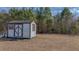 Small outbuilding or shed with a double door and a single window at 2830 Wire Rd, Saint George, SC 29477