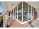 Enclosed brick porch with a patterned floor, offering a sunlit space at 2830 Wire Rd, Saint George, SC 29477
