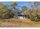 Scenic aerial view of a house surrounded by lush trees and marshland, providing a peaceful setting at 2947 Deer Point Dr, Seabrook Island, SC 29455