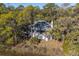 Aerial view of a stately home nestled among mature trees, offering serene privacy and scenic beauty at 2947 Deer Point Dr, Seabrook Island, SC 29455