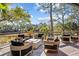 Outdoor deck with fire pit, modern seating, and serene natural views perfect for entertaining at 2947 Deer Point Dr, Seabrook Island, SC 29455