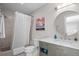 Well-lit bathroom featuring a modern vanity, a round mirror, and a shower with a curtain at 2947 Deer Point Dr, Seabrook Island, SC 29455