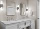 Bathroom featuring dual vanities with marble countertops, modern lighting, and white cabinetry at 2947 Deer Point Dr, Seabrook Island, SC 29455