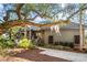 Inviting home exterior with landscaped yard and large tree offering shade at 2947 Deer Point Dr, Seabrook Island, SC 29455