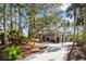 Stunning home exterior featuring lush landscaping, a circular driveway, and mature trees at 2947 Deer Point Dr, Seabrook Island, SC 29455