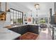 Modern kitchen featuring dark cabinets, marble countertops, an undermount sink, and a breakfast nook with a view at 2947 Deer Point Dr, Seabrook Island, SC 29455