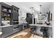 Elegant kitchen with stainless steel appliances, gray cabinets, marble countertops, and a breakfast bar at 2947 Deer Point Dr, Seabrook Island, SC 29455
