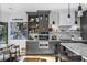 Beautiful kitchen with modern appliances, gray cabinets, marble countertops, and a view of the dining area at 2947 Deer Point Dr, Seabrook Island, SC 29455