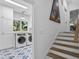 Hallway view into laundry room with modern appliances and beautiful patterned tile at 2947 Deer Point Dr, Seabrook Island, SC 29455