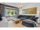 Bright and airy living room featuring a large sofa, bay window with seating, and modern decor at 2947 Deer Point Dr, Seabrook Island, SC 29455
