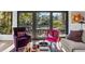 Bright living room with black framed glass doors leading to a deck, modern lighting, and stylish furniture at 2947 Deer Point Dr, Seabrook Island, SC 29455