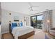 Bright bedroom featuring a ceiling fan, a cozy bed, and access to a private balcony with scenic views at 2947 Deer Point Dr, Seabrook Island, SC 29455