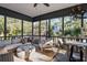 Inviting screened porch with comfortable seating and views of lush greenery at 2947 Deer Point Dr, Seabrook Island, SC 29455