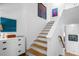 Stairway with wood treads, white risers, and artwork on walls, leading to upper level at 2947 Deer Point Dr, Seabrook Island, SC 29455