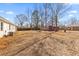 Spacious backyard featuring mature trees, a storage shed, and partial fencing at 3 Coral Dr, Goose Creek, SC 29445